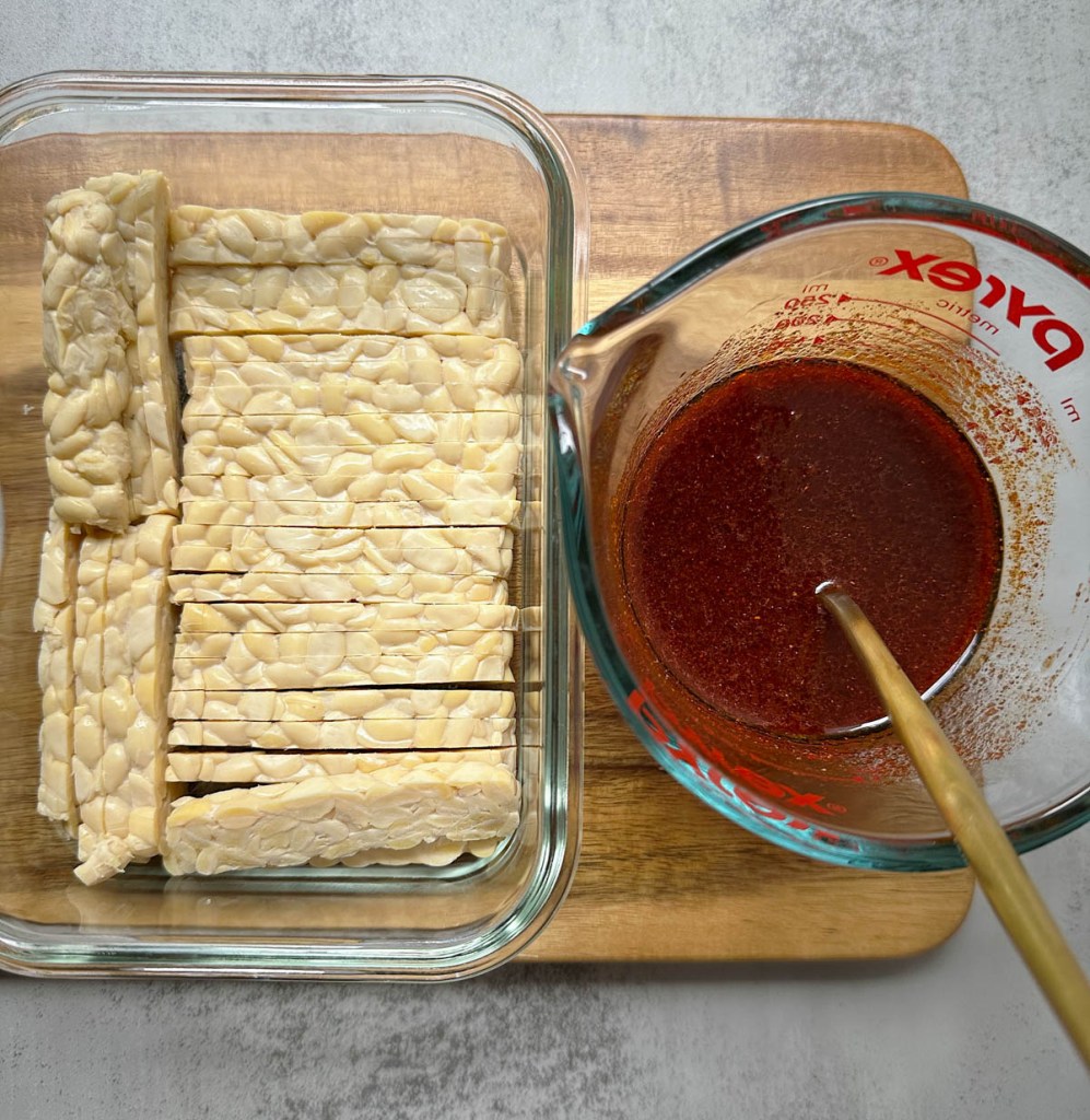 ingredients for smoky maple tempeh bacon on a wooden cutting board