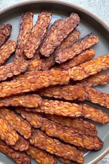 tempeh bacon arranged on a plate