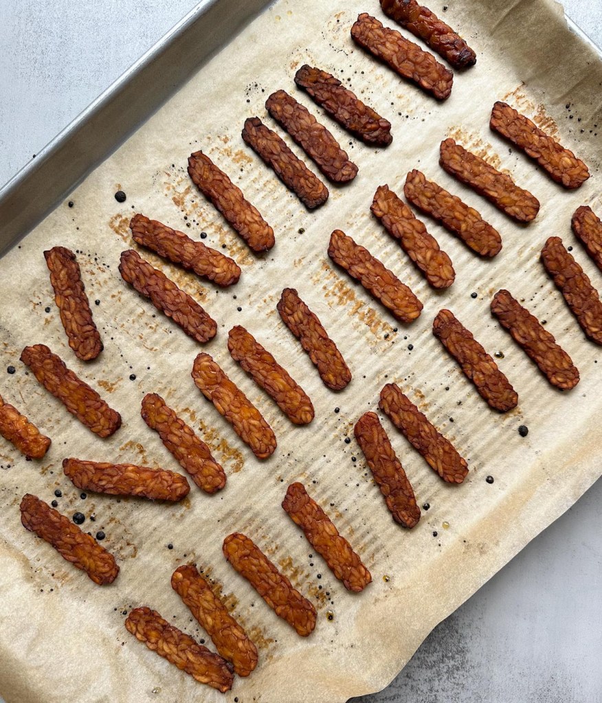 smoky maple tempeh bacon on a baking sheet