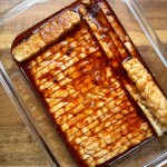smoky maple tempeh bacon marinating in a glass dish