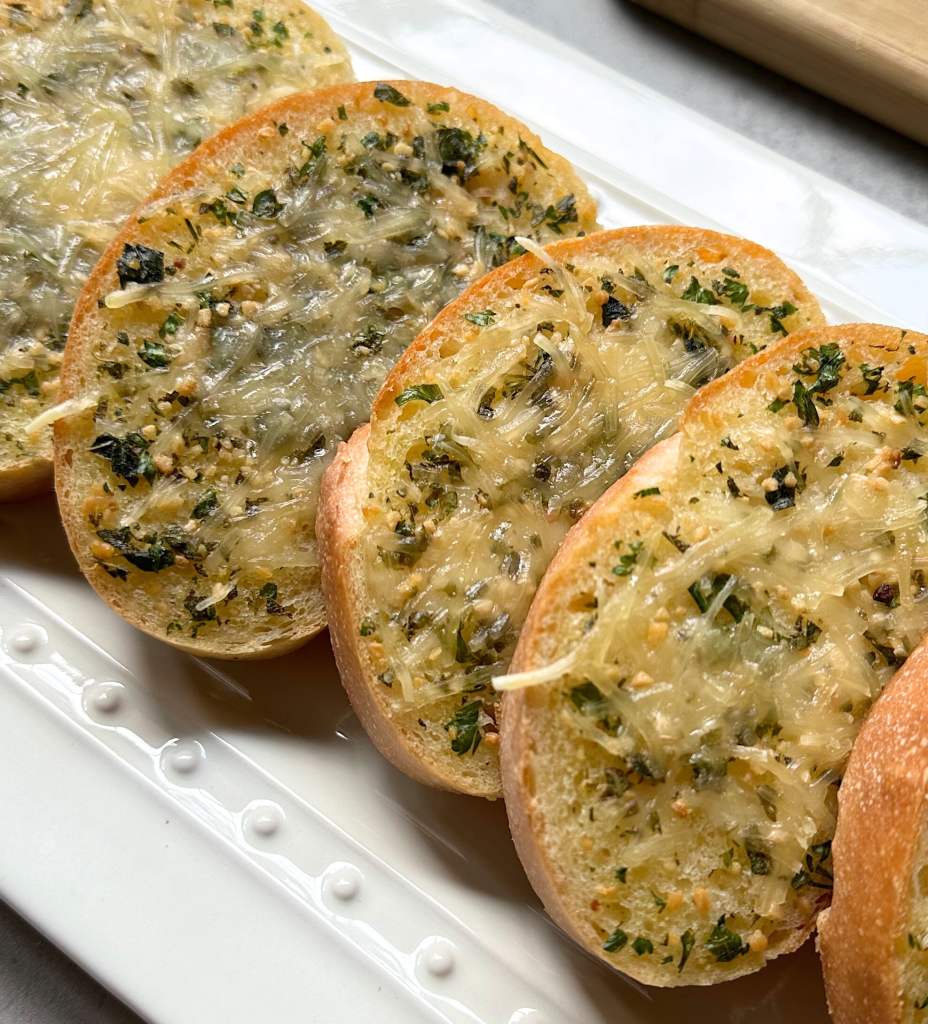 vegan cheesy garlic bread on a white plate