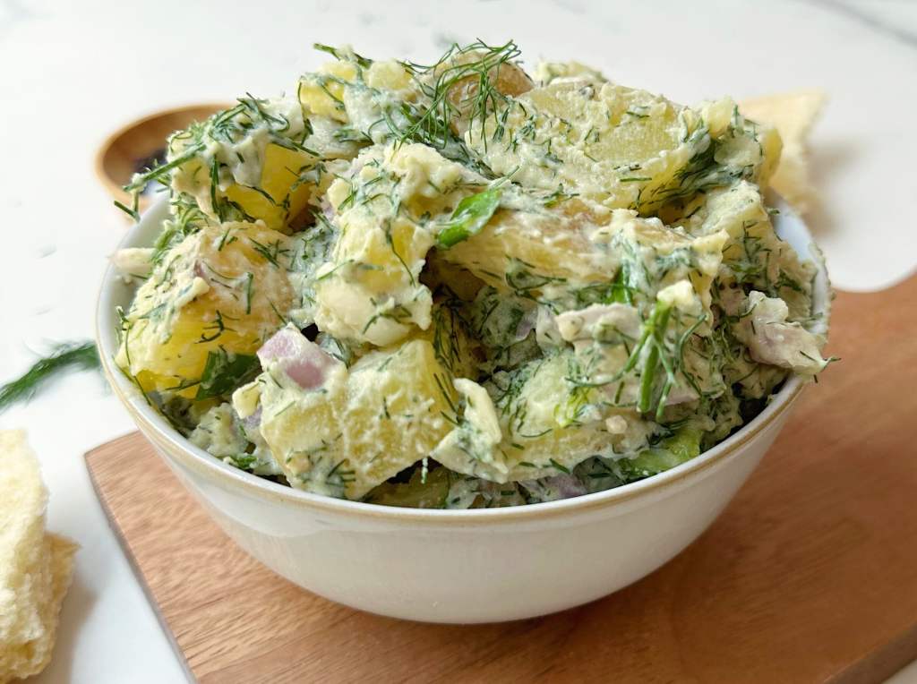 vegan dill potato salad in a small white bowl