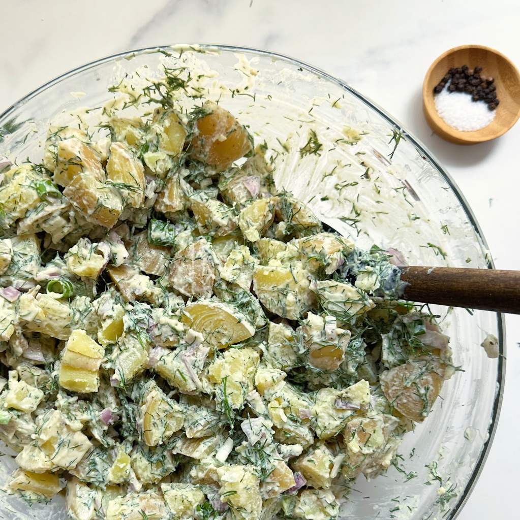 finished vegan dill potato salad in a glass bowl