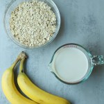 ingredients for banana oat pancakes on grey background