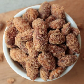 Top view vegan cinnamon sugar candied almonds in a white bowl