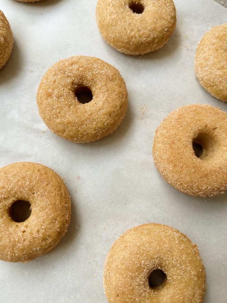 vegan cinnamon sugar donuts on a baking sheet