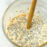mason jar showing vegan coconut mango chia pudding after being stirred