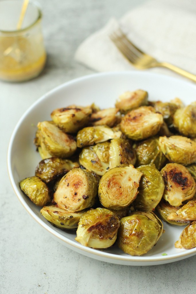 roasted maple dijon brussels sprouts in a white bowl
