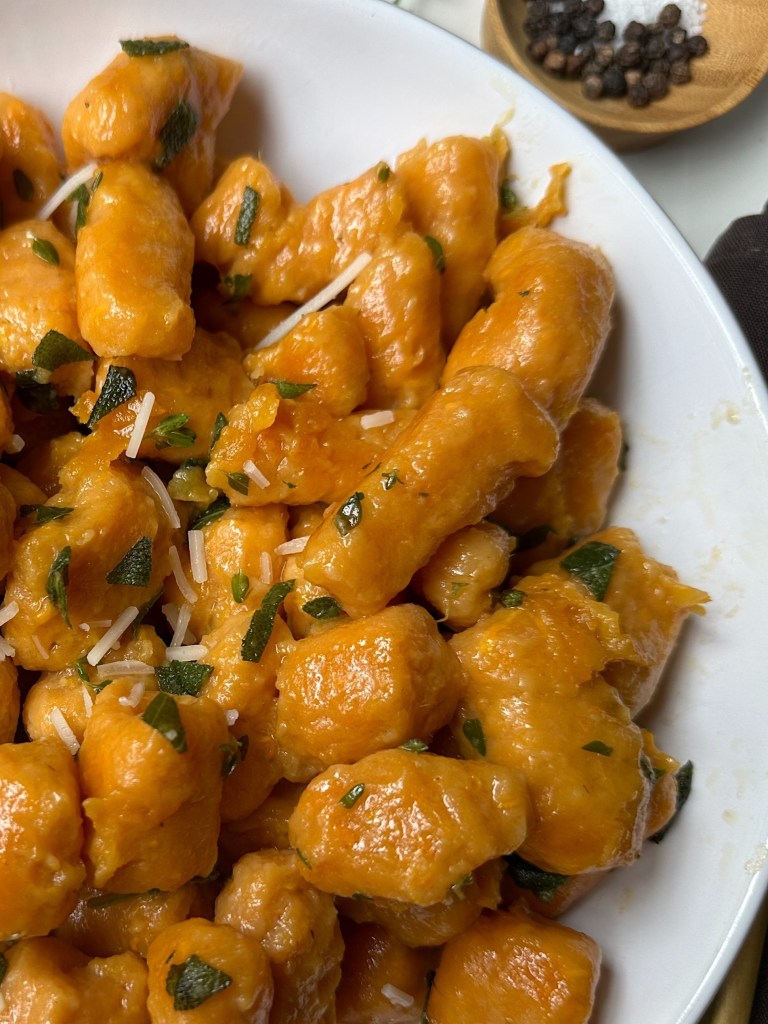 finished vegan sweet potato gnocchi with vegan parmesan cheese on top