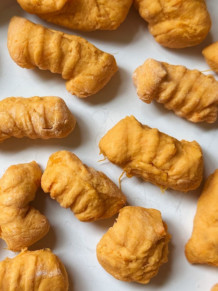 close up of raw, shaped vegan sweet potato gnocchi
