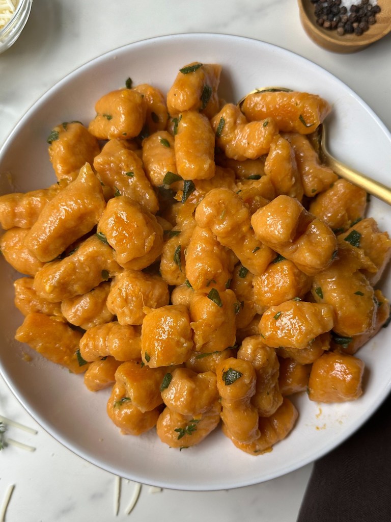 finished vegan sweet potato gnocchi in a white bowl
