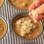 applying streusel topping to muffin batter before baking