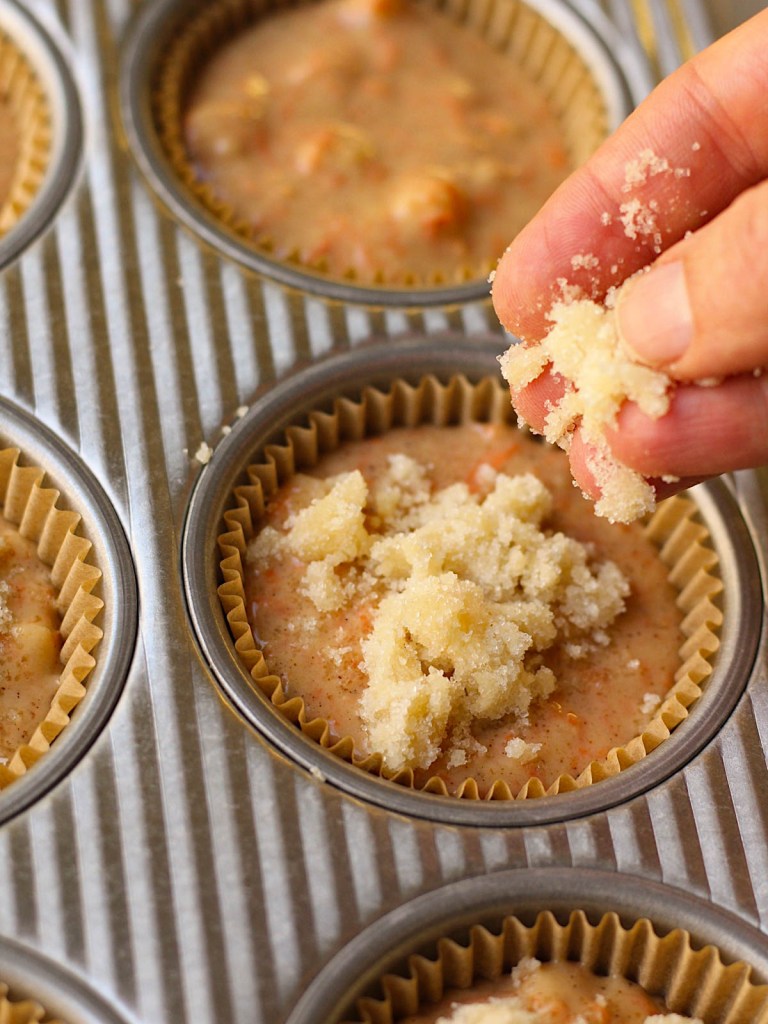 applying streusel topping to muffin batter before baking