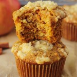 vegan carrot apple muffins stacked with a bite taken out of the top one