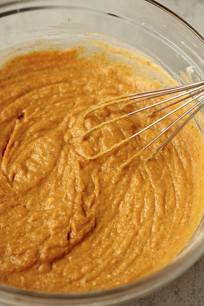 vegan pumpkin pie filling in a glass bowl after being mixed