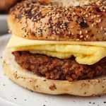 vegan breakfast sausage patty in a bagel sandwich