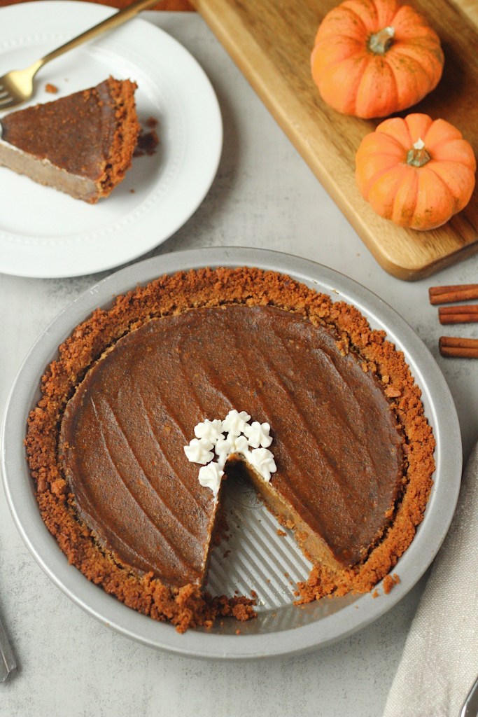 vegan pumpkin pie with slice taken out