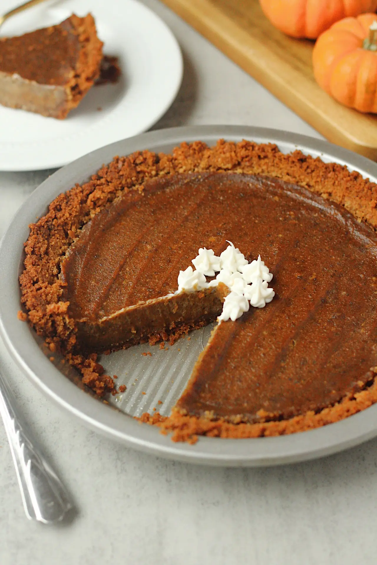 vegan pumpkin pie with slice taken out