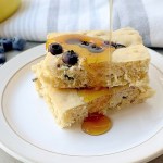 easy vegan sheet pan pancakes with syrup pouring over