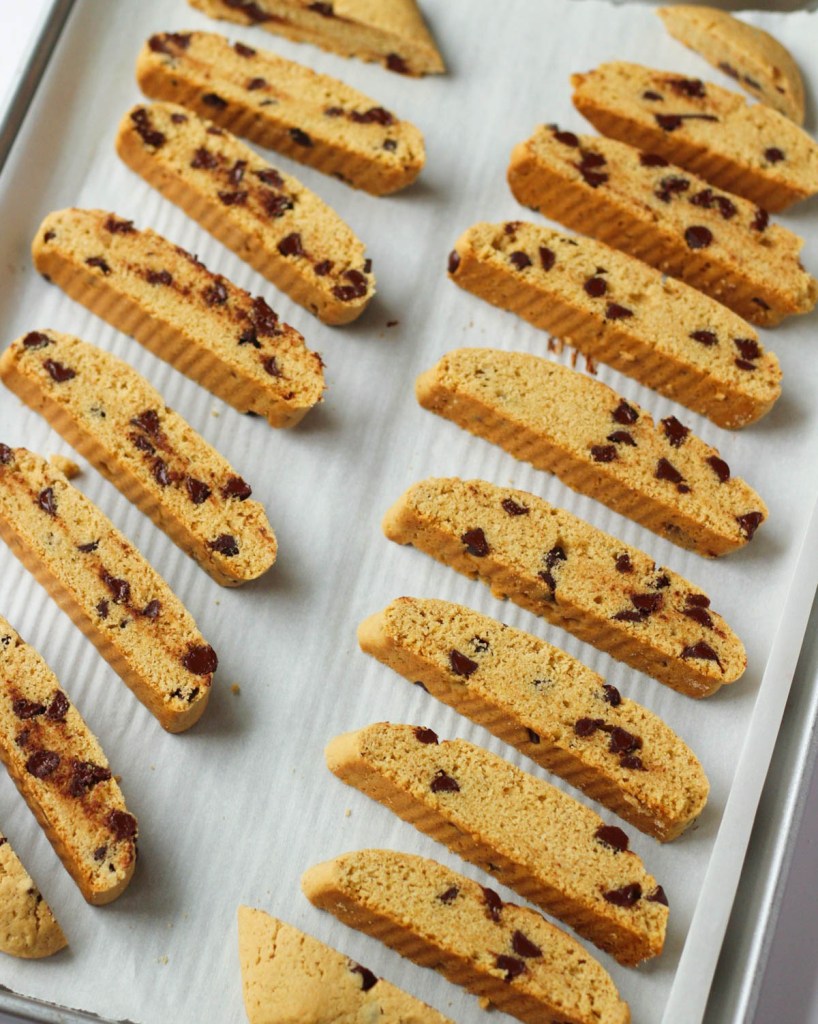 finished vegan chocolate chip biscotti on a baking sheet