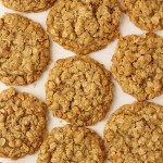 finished oatmeal cookies layed out to cool on parchment paper
