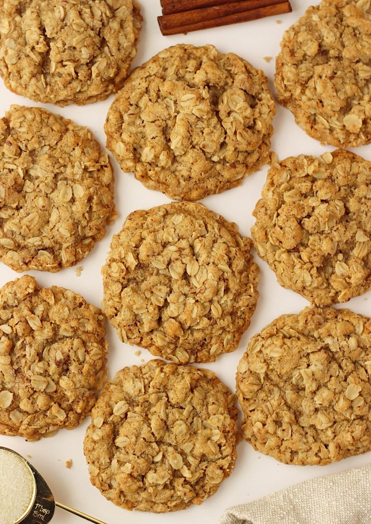 finished oatmeal cookies layed out to cool on parchment paper