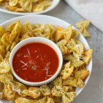 pasta chips in a bowl with marinara sauce