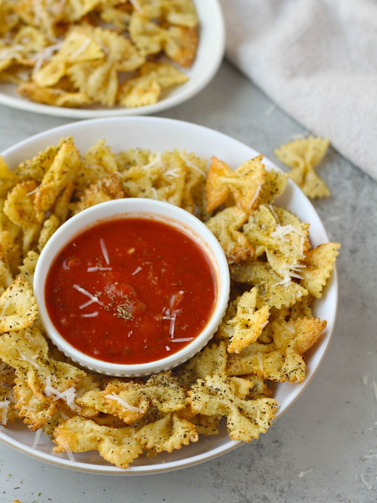 pasta chips in a bowl with marinara sauce