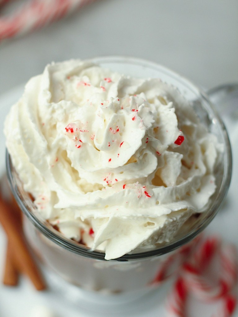top view of whipped cream with crushed candy canes on homemade hot chocolate