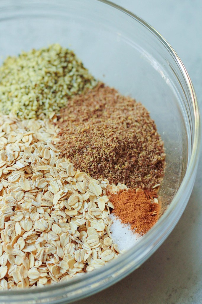 dry ingredients added to mixing bowl for vegan baked oatmeal cups