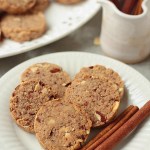 keto almond cookies on white plate with cinnamon sticks