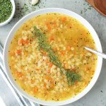 top view vegan pastina soup in a white bowl