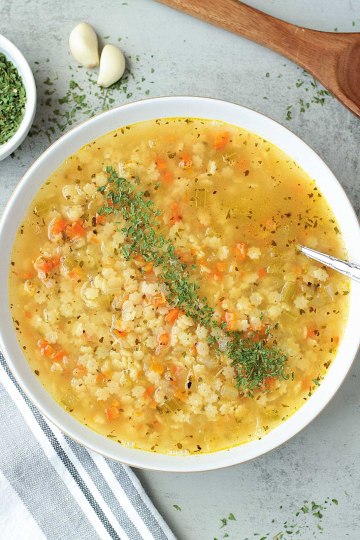 top view vegan pastina soup in a white bowl