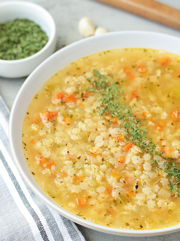 vegan pastina soup in a white bowl