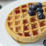 close up vegan protein waffles with syrup and blueberries