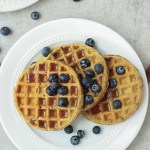 top view vegan protein waffles with maple syrup and blueberries