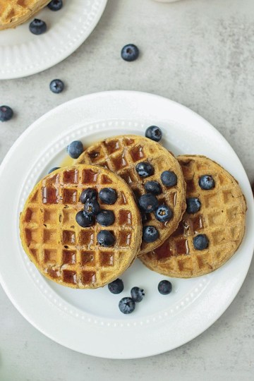 top view vegan protein waffles with maple syrup and blueberries