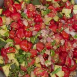 chopped veggies and herbs in saute pan