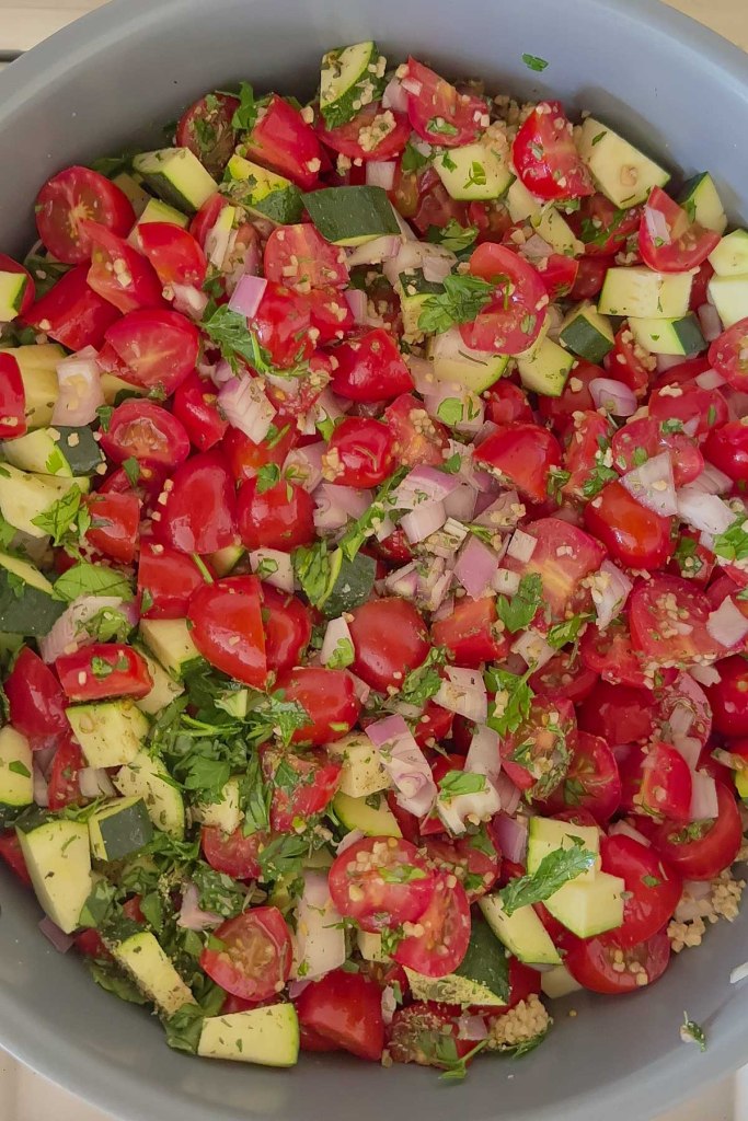 chopped veggies and herbs in saute pan