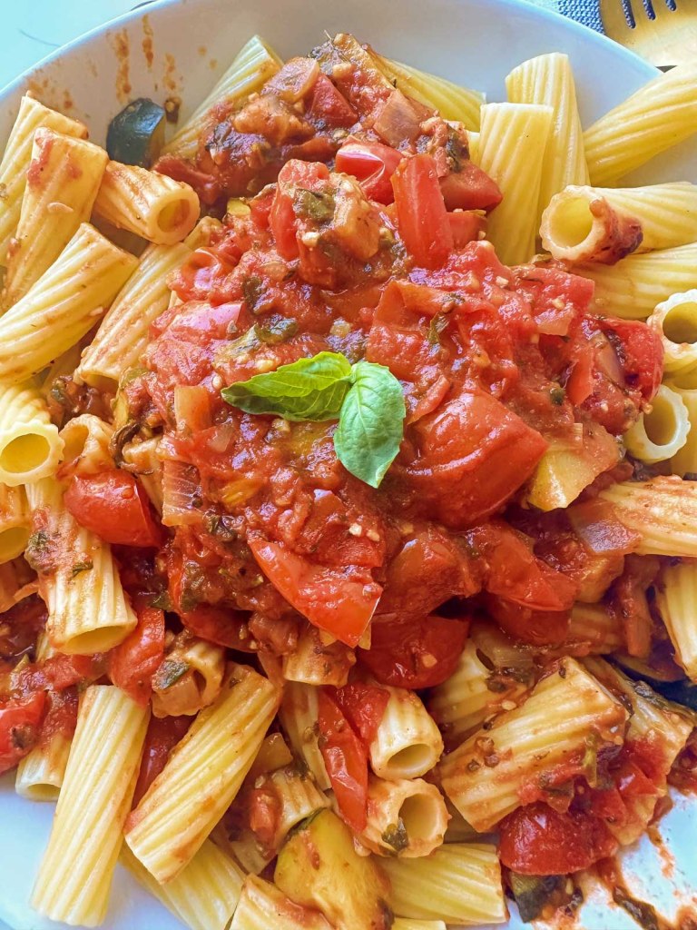 close up garden veggie pasta sauce on noodles