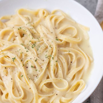 vegan fettuccine alfredo in a white bowl