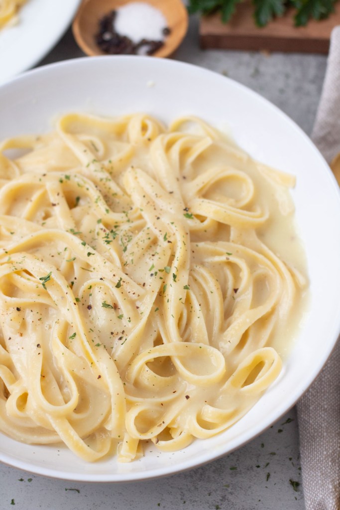 vegan fettuccine alfredo in a white bowl