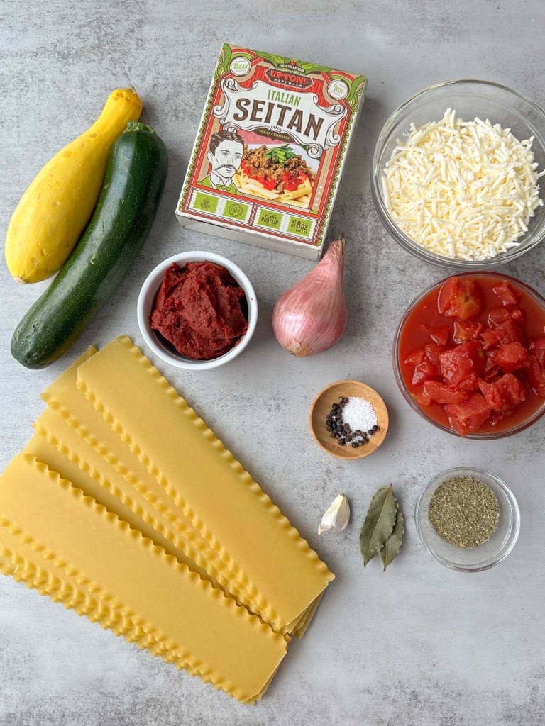 ingredients for vegan lasagna soup on a grey background