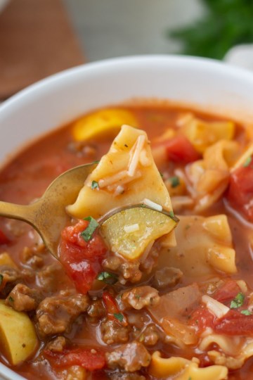 close up of spoonful of vegan lasagna soup