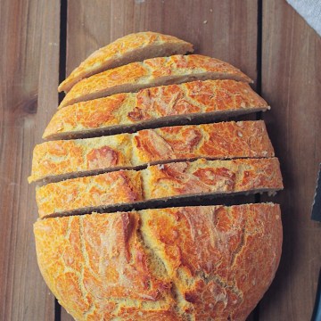 sliced artisan bread on wood board background