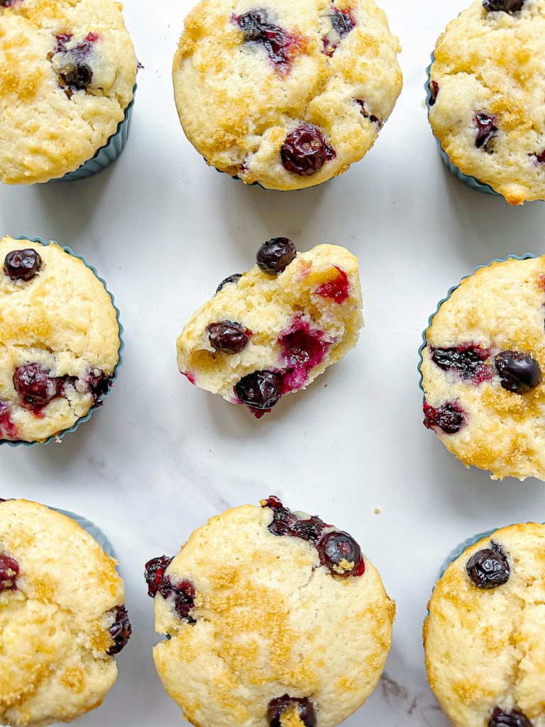 lemon blueberry muffins with one split open to show crumb