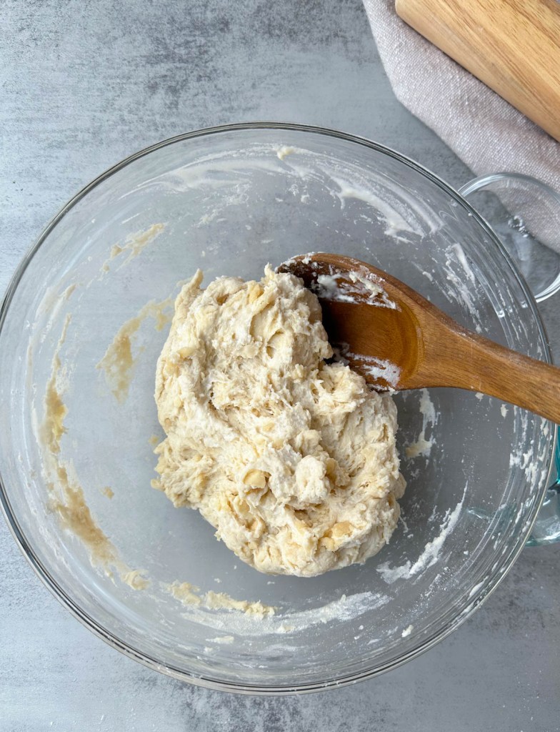 dough for flour tortillas immediately after mixing in a glass bowl. Showing shaggy texture