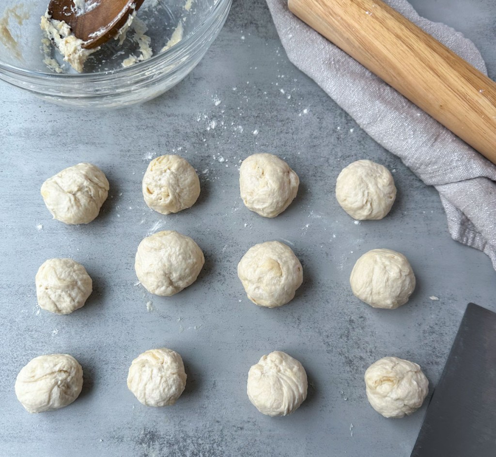 12 balls of flour tortilla dough rolled and ready to rest