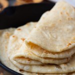finished tortillas folded in a cast iron skillet