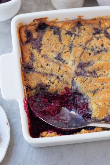 finished vegan blackberry cobbler with spoonful taken out